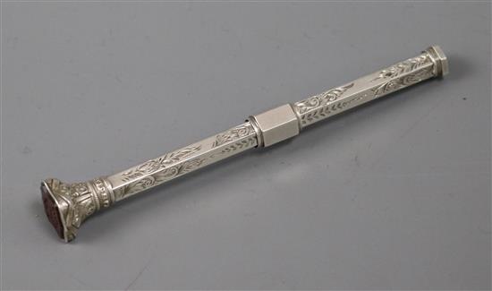 A late 19th/early 20th century white metal propelling pencil with carnelian set seal top.